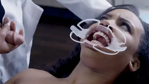 Medic penetrates face of astonished patient in the medical center